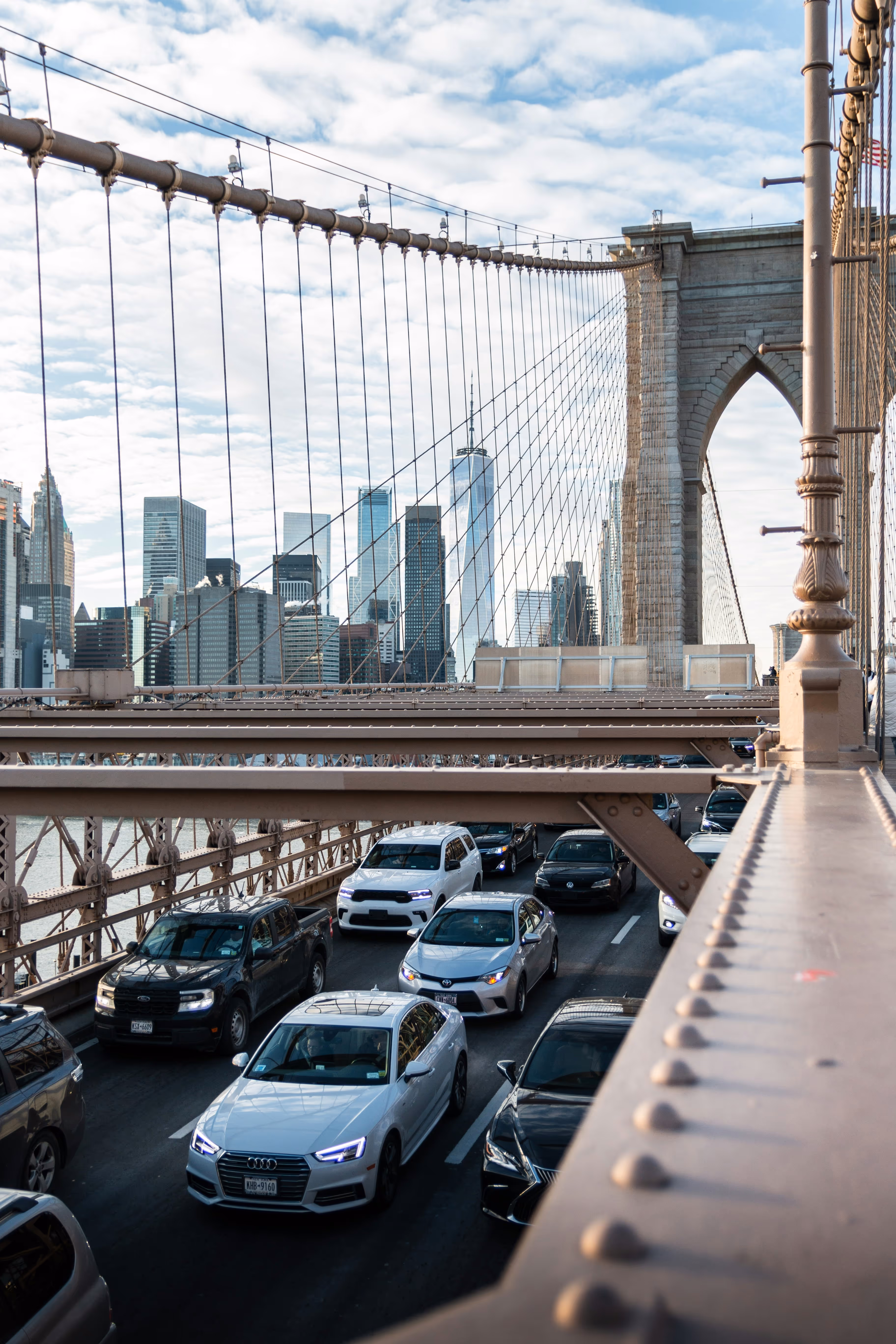 Passenger vehicles driving through Brooklyn Bridge