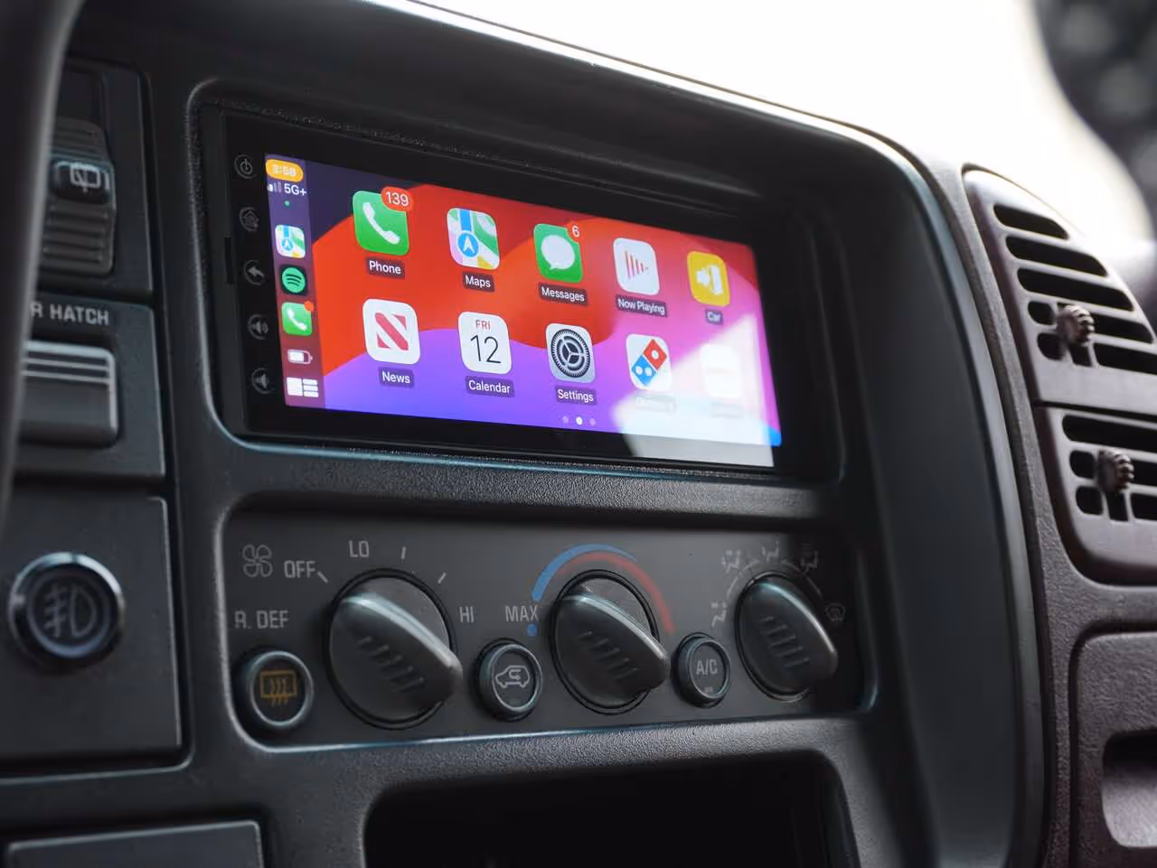 Mechanic installing an Android head unit in a car